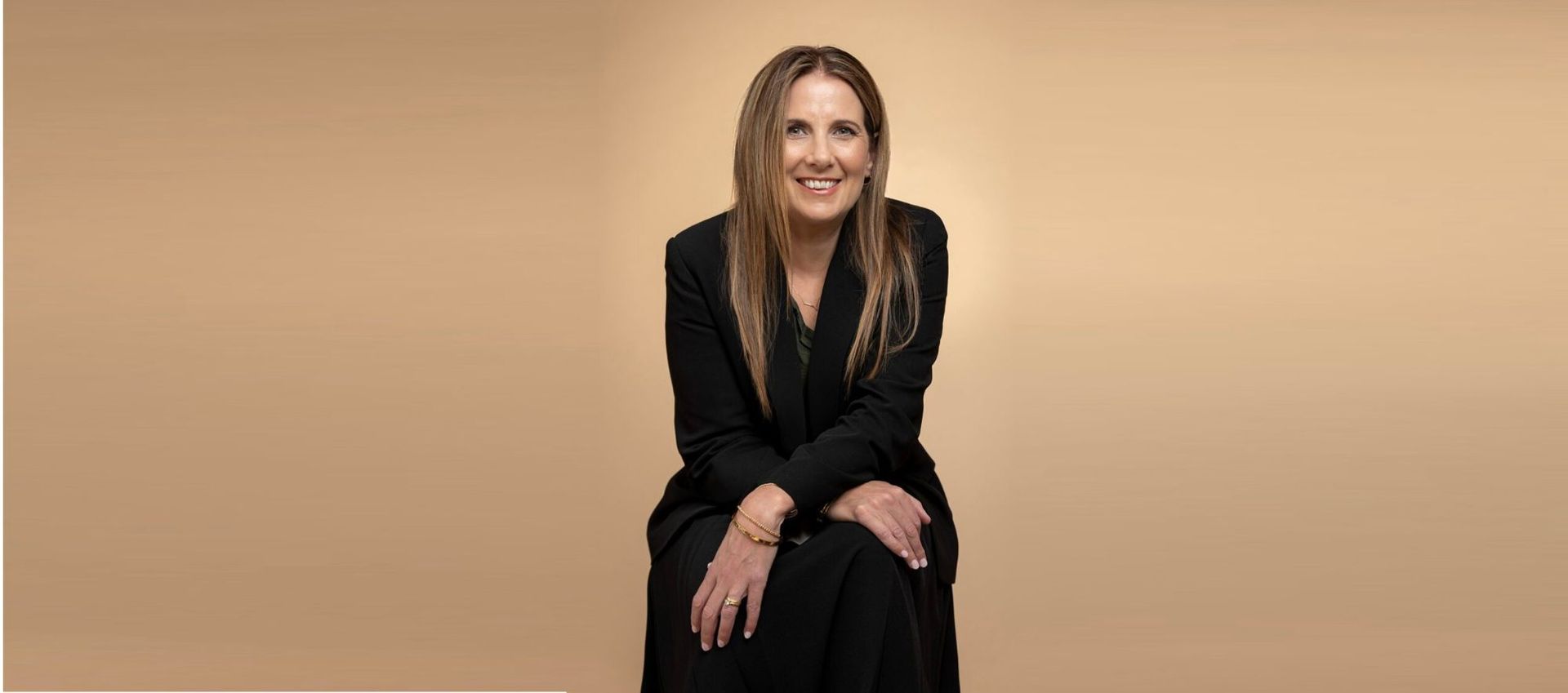 Paulette Coombes, mindset coach and former registered nurse, seated portrait